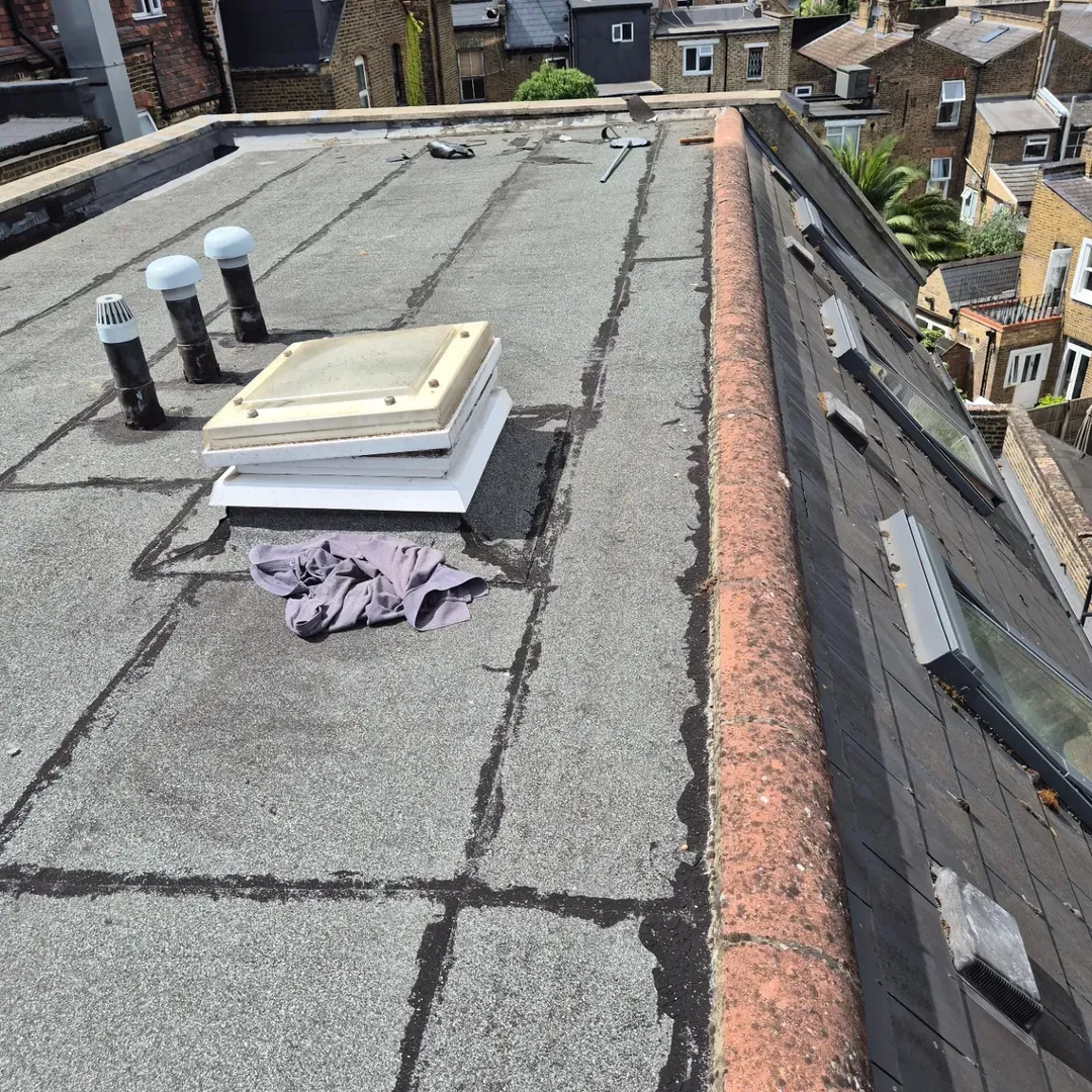 Failed felt around a rooflight and vents before waterproofing