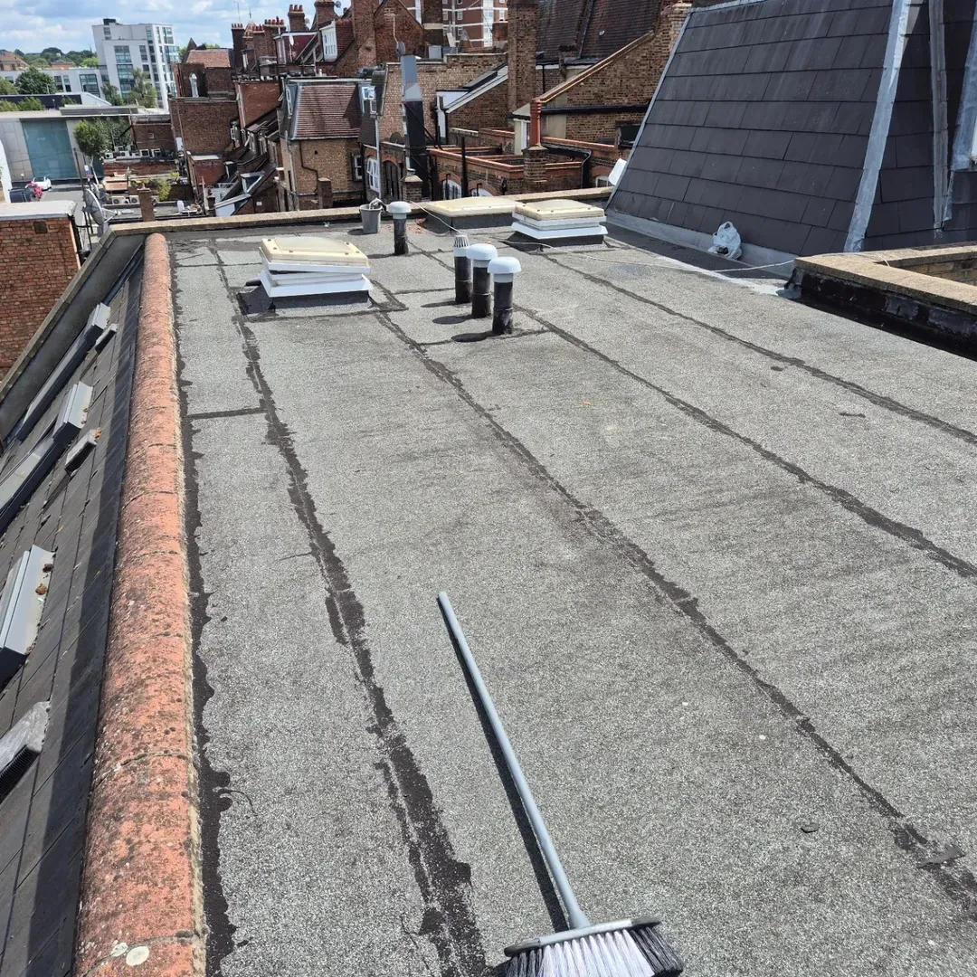 Worn, failed felt flat roof before refurbishment