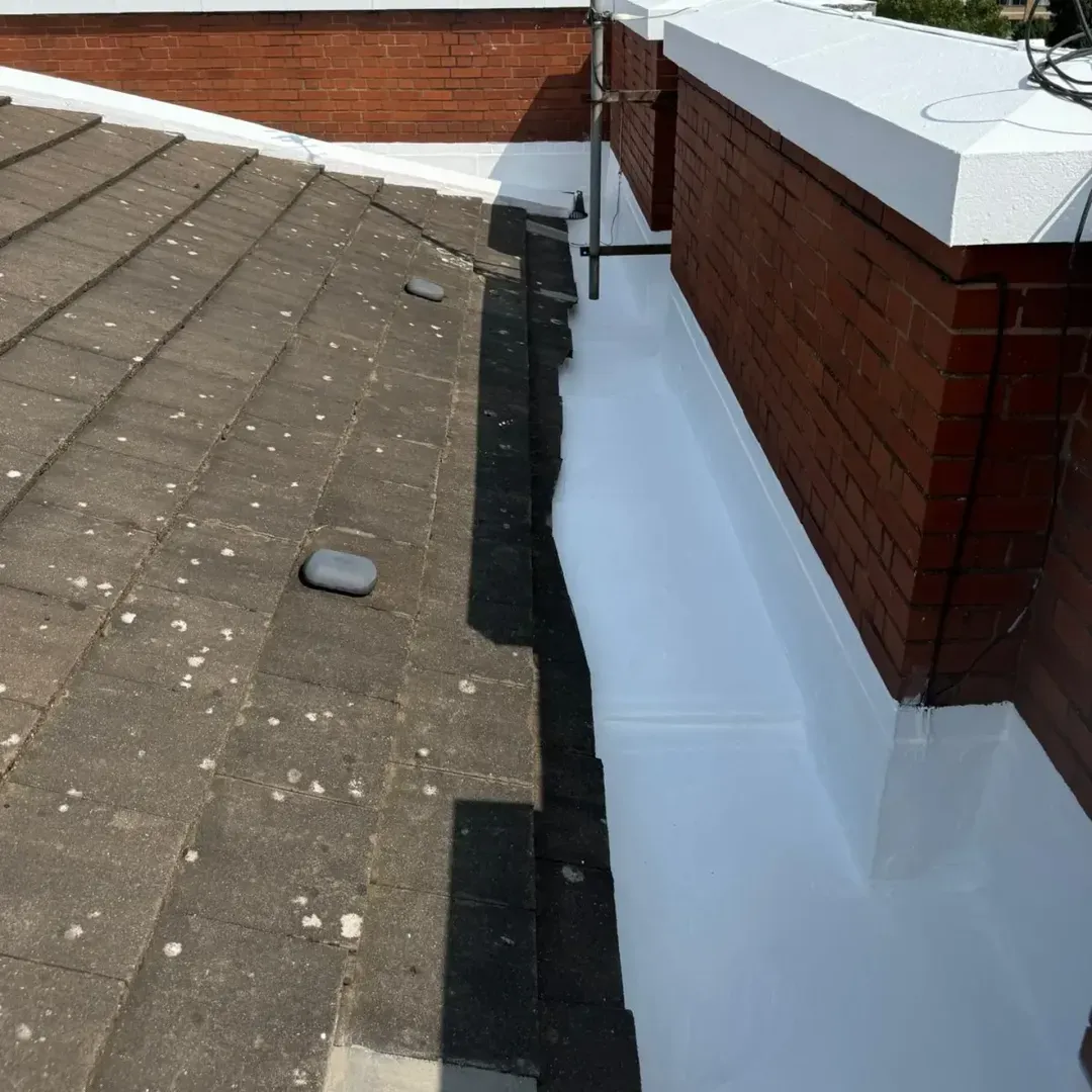 A lead valley gutter and parapet junction sealed white with the HYDRONYLON system