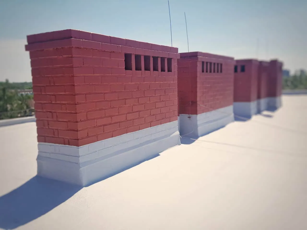 Flat roof in London sealed with the HYDRONYLON liquid-applied system, with chimney details waterproofed