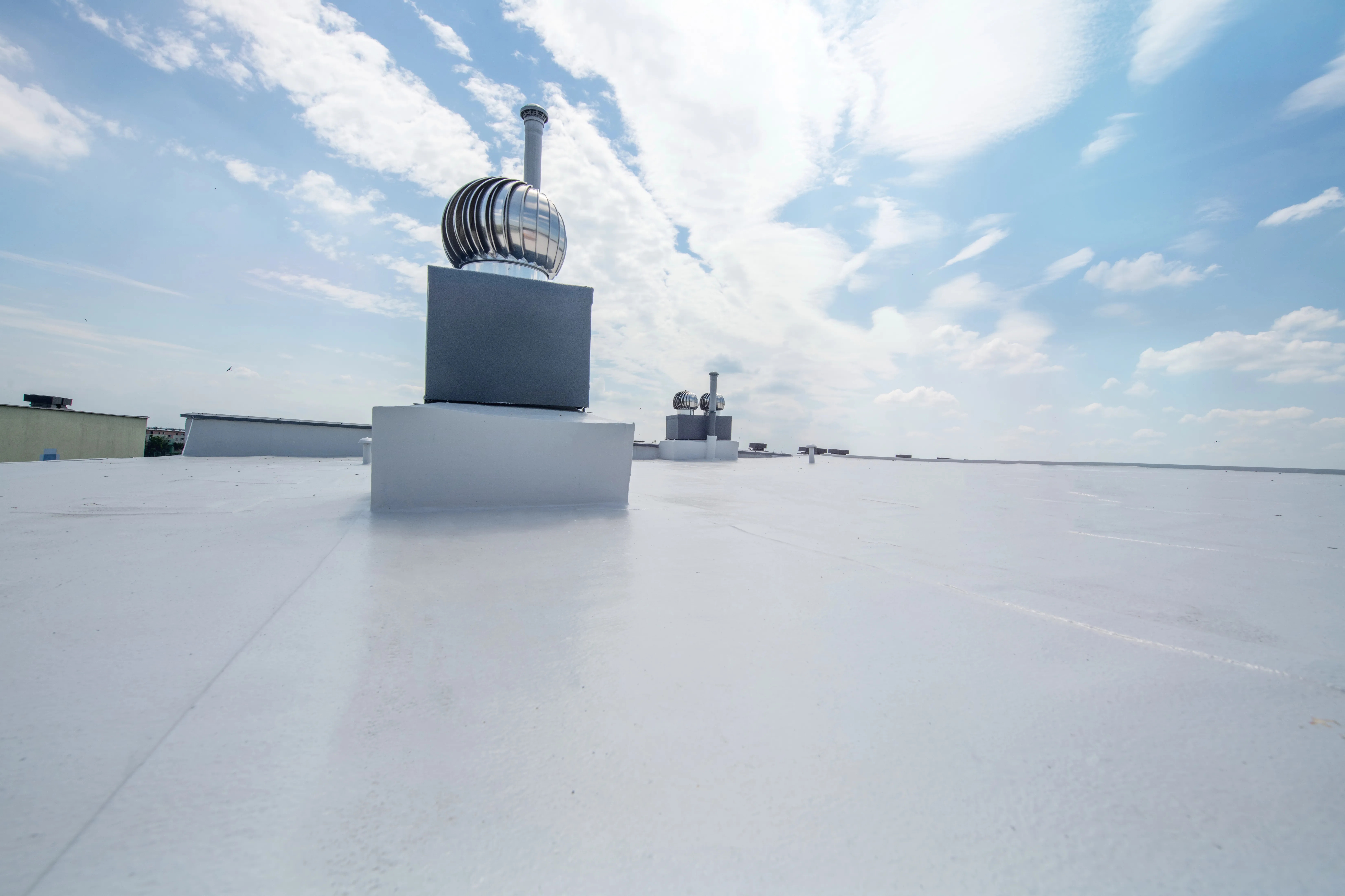 White reflective HYDRONYLON liquid roofing membrane sealed over a flat roof in London